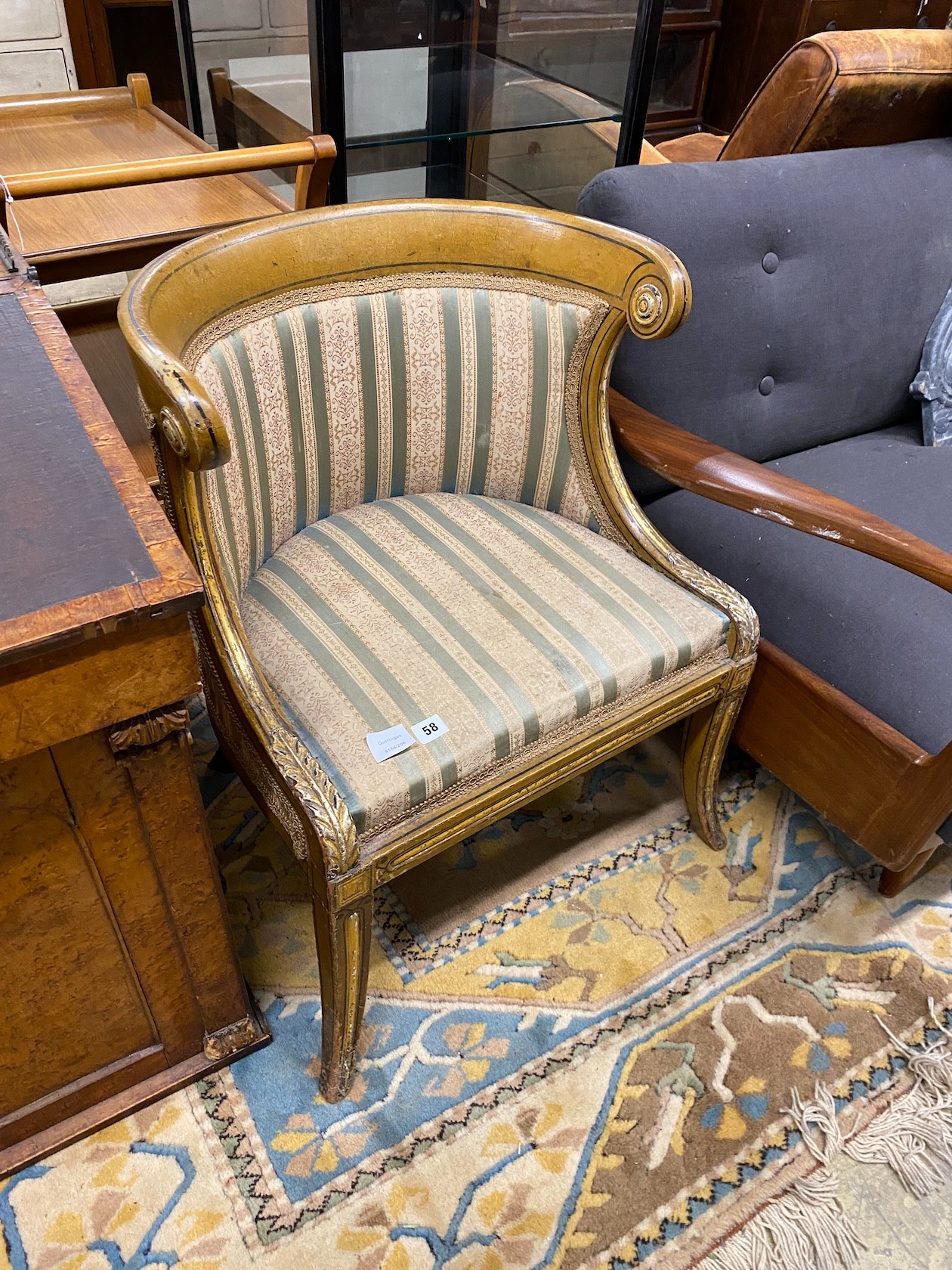 A Regency painted, parcel gilt upholstered side chair with scroll back and acanthus mounts over swept legs, width 56cm, depth 45cm, height 73cm